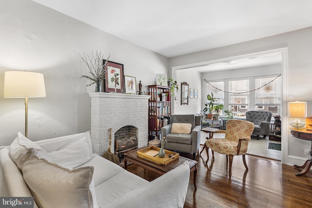 living room with wood finished floors and a fireplace