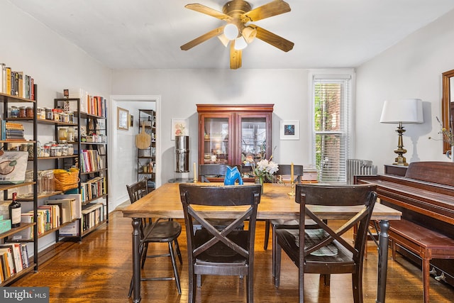 dining space with wood finished floors and ceiling fan