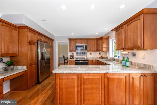 kitchen with stainless steel appliances, a peninsula, light wood-style flooring, open shelves, and light stone counters