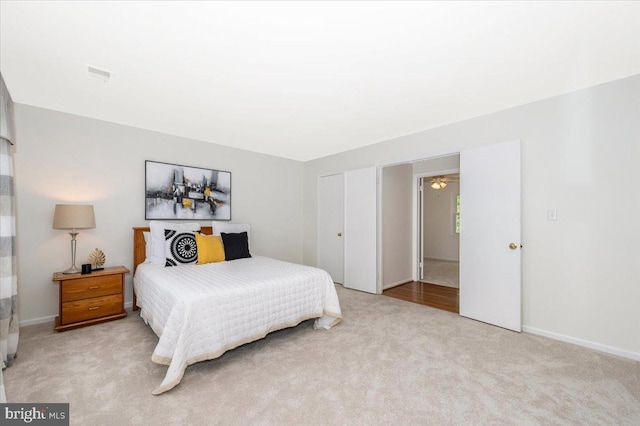 bedroom featuring light colored carpet and a closet