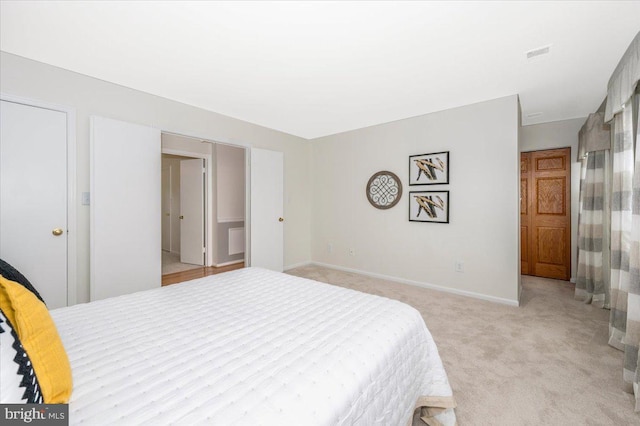 bedroom featuring light carpet and baseboards