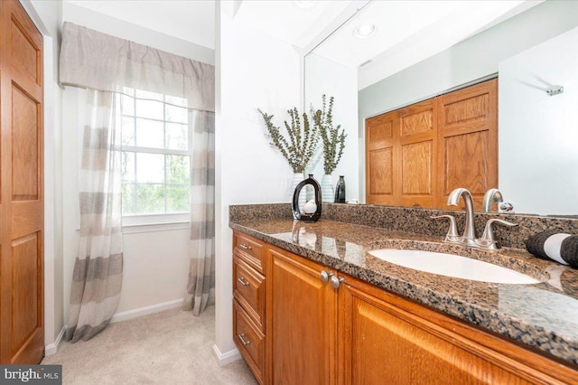 bathroom with vanity, baseboards, and curtained shower