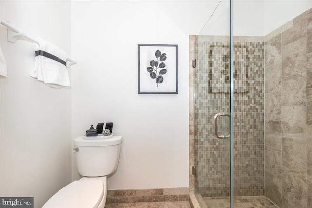 full bathroom with a stall shower and toilet