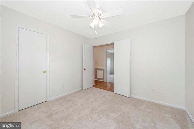unfurnished bedroom with carpet floors, baseboards, and ceiling fan