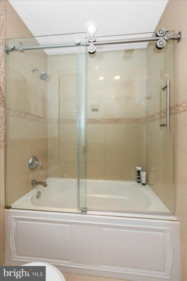 full bath featuring bath / shower combo with glass door
