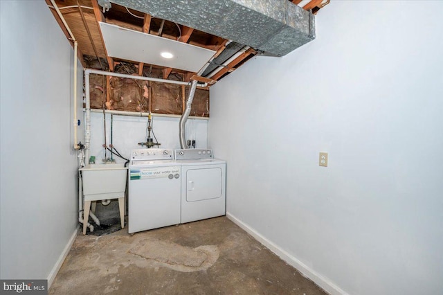 laundry room featuring separate washer and dryer and baseboards