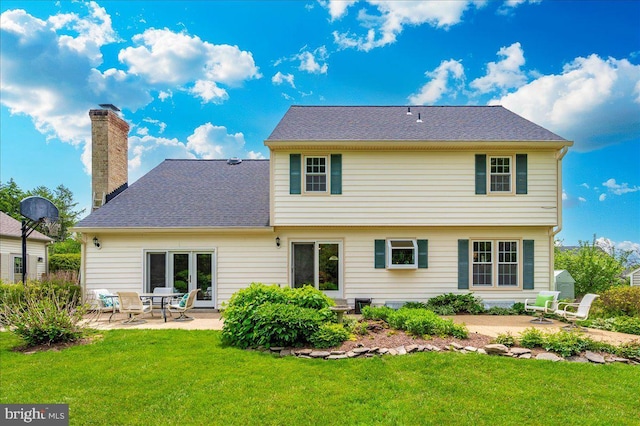 back of property featuring a patio, a lawn, and a chimney