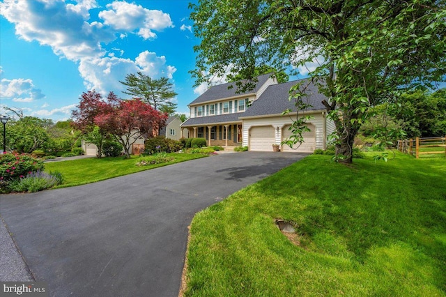 view of front facade featuring asphalt driveway and a garage