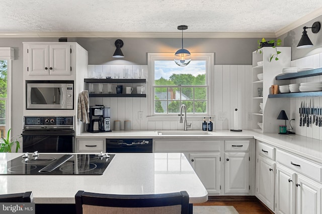 kitchen featuring black appliances, a sink, open shelves, healthy amount of natural light, and ornamental molding