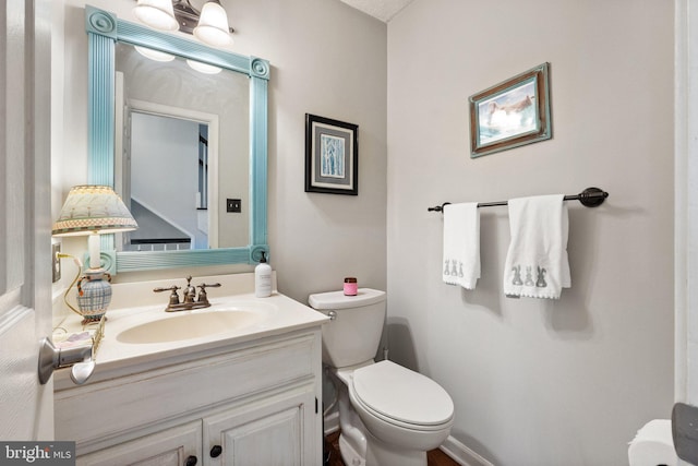 half bath featuring toilet and vanity