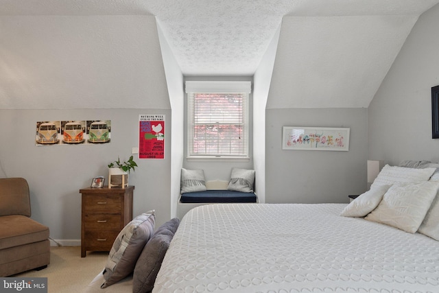 bedroom featuring lofted ceiling, light colored carpet, and a textured ceiling