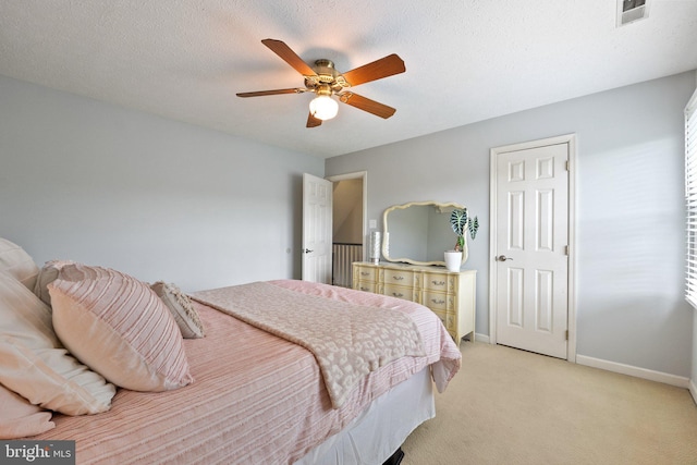 bedroom featuring light colored carpet, baseboards, and ceiling fan