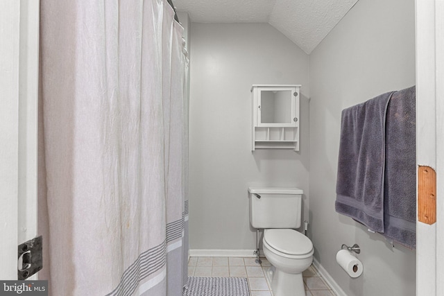 full bath featuring a textured ceiling, tile patterned flooring, baseboards, toilet, and lofted ceiling