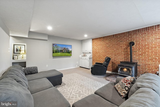 living room with a wood stove, light carpet, baseboards, and recessed lighting