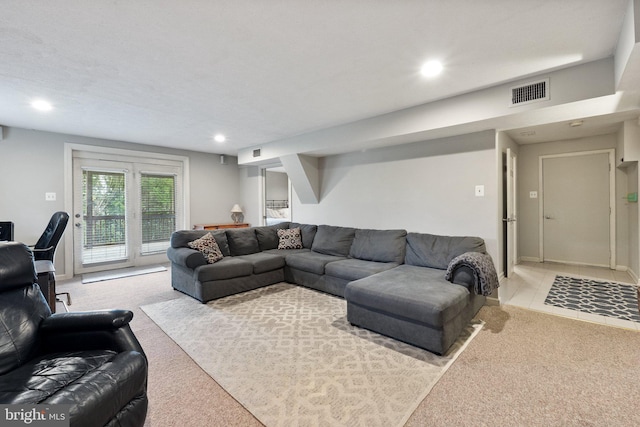 living area featuring light carpet and recessed lighting
