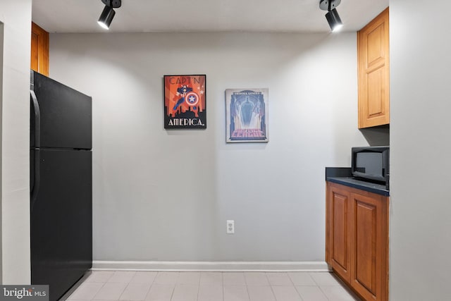 kitchen with black appliances, baseboards, and dark countertops