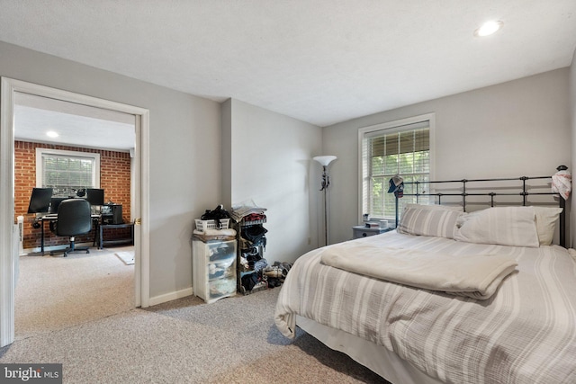 carpeted bedroom with an office area, multiple windows, and recessed lighting