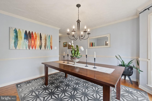 office area featuring a chandelier, crown molding, baseboards, wood finished floors, and a textured ceiling