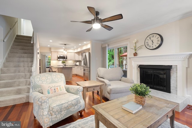 5731 Wooden Spoon Ct, Burke, VA 22015 - living area with a ceiling fan, stairway, a glass covered fireplace, light wood finished floors, and crown molding
