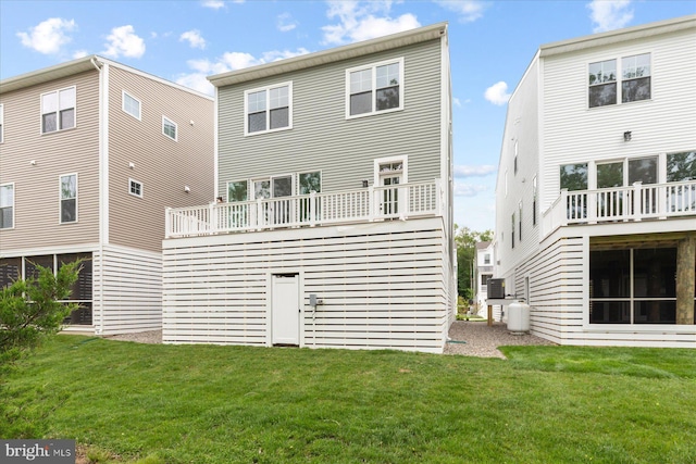 31447 Watershed Ln Unit 2, Bethany Beach, DE 19930 - rear view of house featuring a lawn and a balcony