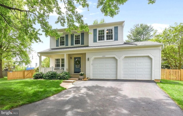 view of front of property featuring a porch and asphalt driveway