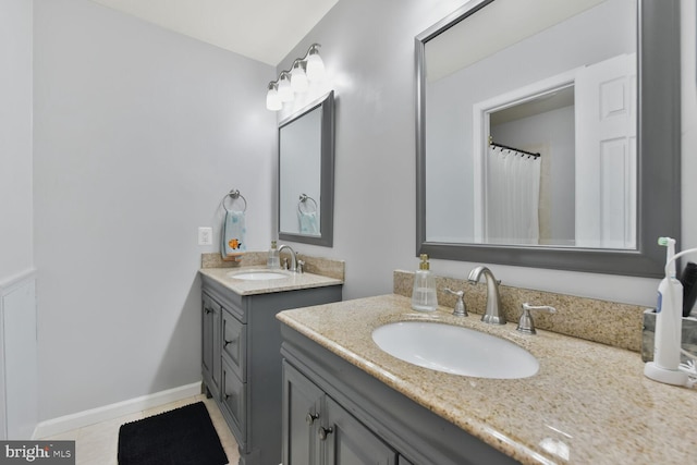 full bath with two vanities and tile patterned floors