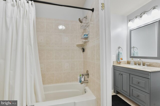 full bathroom featuring shower / bath combo with shower curtain and vanity