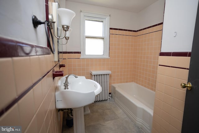 bathroom with radiator heating unit, tile walls, a bathtub, a wainscoted wall, and a shower