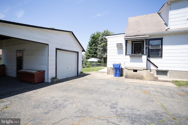 view of front facade featuring a garage, an outdoor structure, and driveway