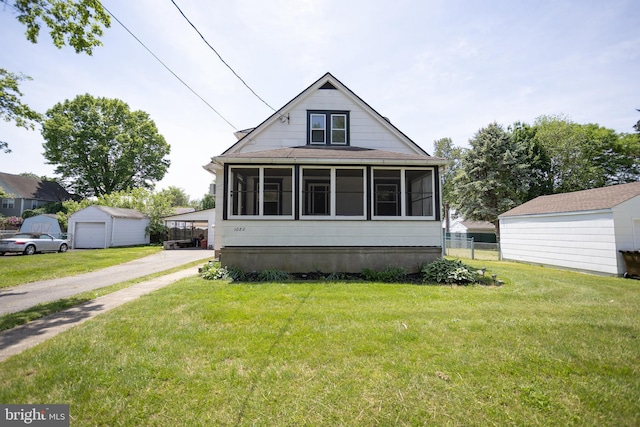 view of front facade featuring a sunroom and an outdoor structure