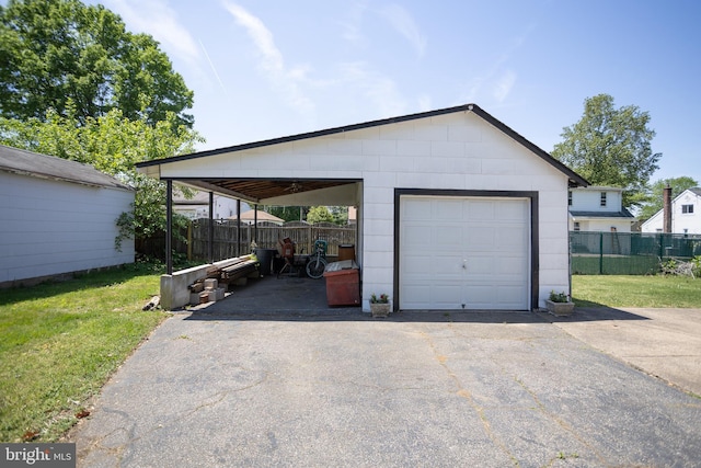 garage with driveway and a garage