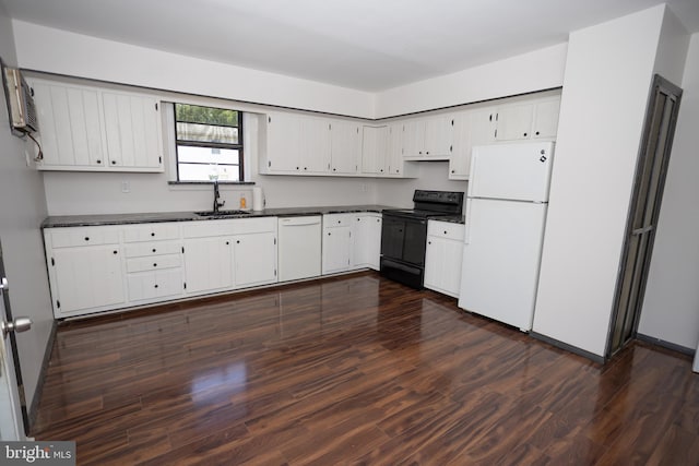 kitchen with white appliances, dark countertops, dark wood-style floors, a sink, and white cabinets