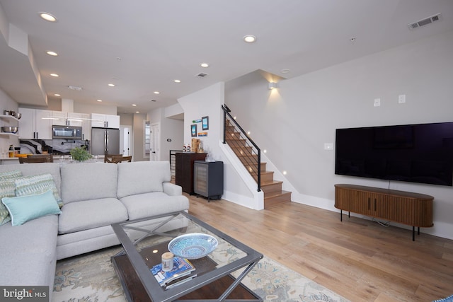 1444 Newton St NW Unit 2, Washington, DC 20010 - living area with light wood-style flooring, recessed lighting, stairway, and baseboards