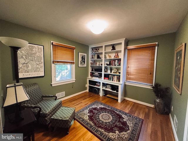 sitting room with wood finished floors and baseboards