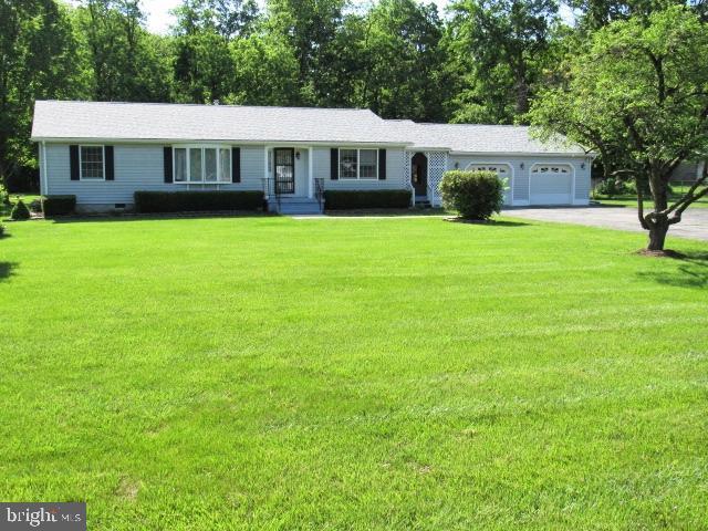 145 Phillips Ln, Bunker Hill, WV 25413 - ranch-style house featuring driveway, an attached garage, and a front lawn