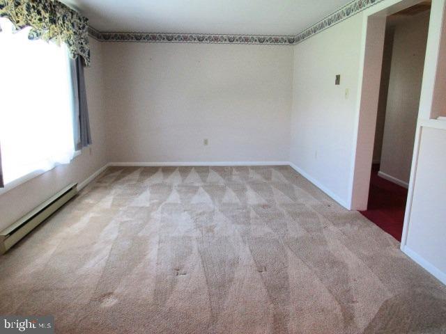 145 Phillips Ln, Bunker Hill, WV 25413 - unfurnished room featuring a baseboard heating unit, carpet floors, and baseboards