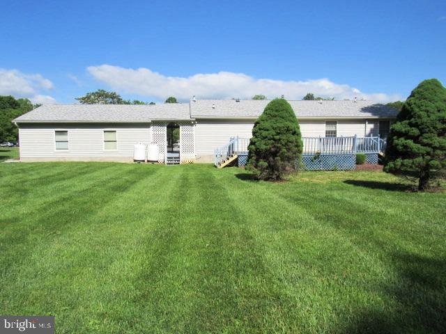 145 Phillips Ln, Bunker Hill, WV 25413 - rear view of property with a lawn and a deck