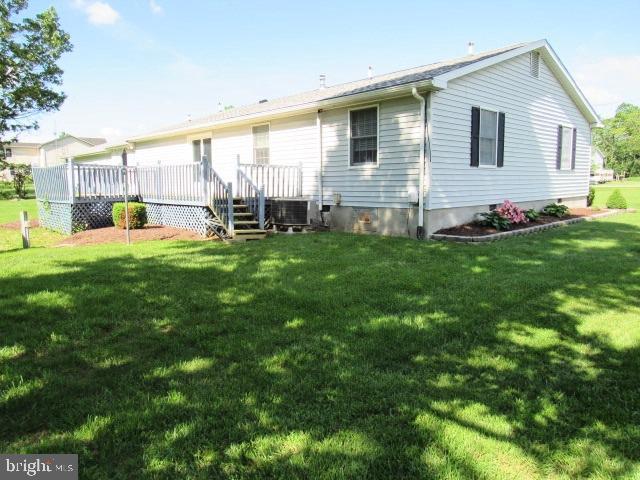 145 Phillips Ln, Bunker Hill, WV 25413 - back of house featuring a deck, a yard, and cooling unit