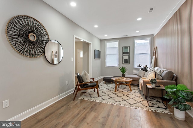 living area with wood finished floors, baseboards, and recessed lighting