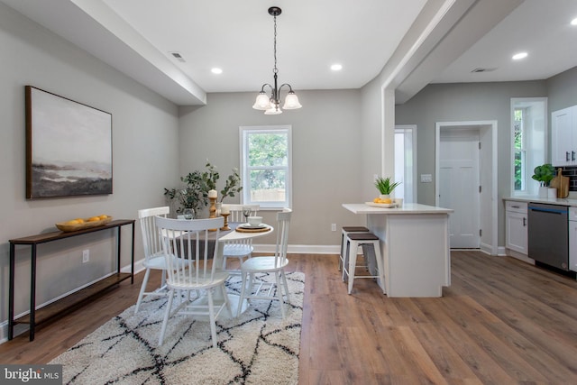 dining room with wood finished floors, baseboards, recessed lighting, and a chandelier