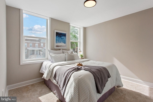 bedroom featuring carpet flooring and baseboards