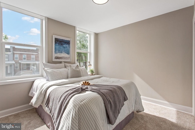 carpeted bedroom featuring baseboards