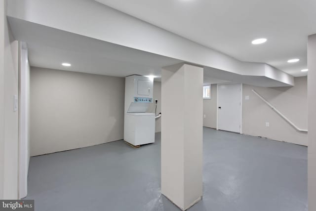 below grade area with stacked washer / dryer and recessed lighting