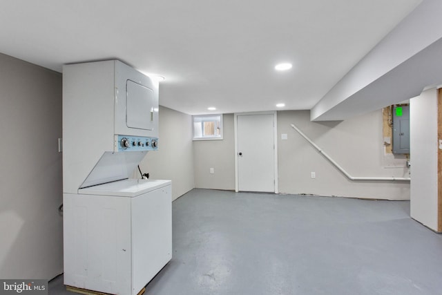 laundry area featuring estacked washer and dryer, electric panel, and recessed lighting