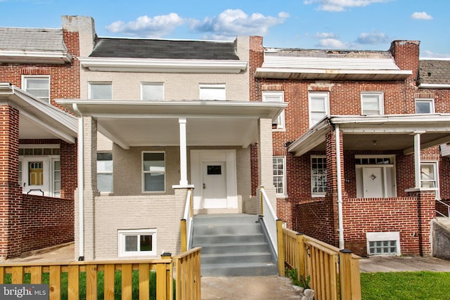 multi unit property with brick siding and fence