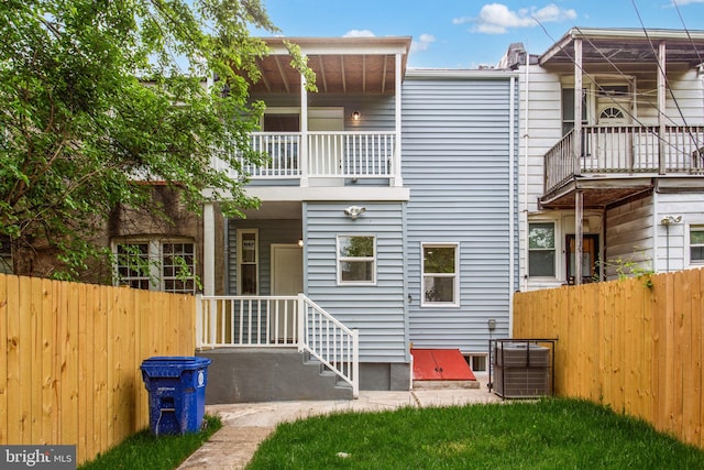 back of house with a balcony, fence, and cooling unit