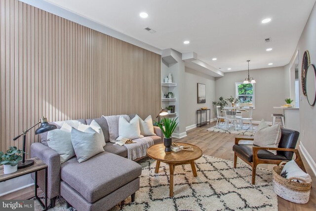 living area featuring wood finished floors, recessed lighting, and baseboards