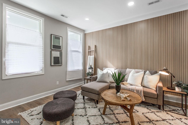 living area featuring wood finished floors, baseboards, healthy amount of natural light, and recessed lighting