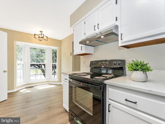 kitchen featuring black electric range oven, under cabinet range hood, light countertops, white cabinets, and light wood-type flooring