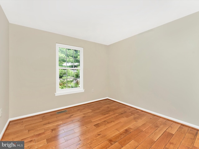 empty room with light wood-style flooring and baseboards